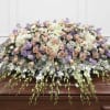A soft pastel palette of blush roses, lavender accents, and whisper-white blooms