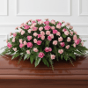 Soft clusters of pink roses and pale pink carnations create a tender