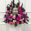 A lush, ceremonial display centered in an ornate silver urn, this Butterfly