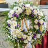 Large floral wreath with white roses and purple flowers