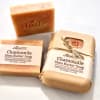 Set of three chamomile shea butter soap bars, one wrapped and two unwrapped on a light surface