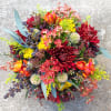Colorful bouquet with red chrysanthemums, orange tulips, and yellow filler flowers