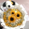 Bouquet of yellow sunflowers and pale roses with a plush panda topper