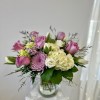 Pink roses and lavender blooms in a glass vase