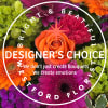Bright mixed arrangement with orange roses, gerbera daisies, pink and purple blooms, and green hydrangea.