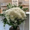 White rose bouquet with baby's breath in a glass vase
