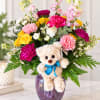 Colorful bouquet with a teddy bear in a purple vase