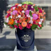 Beautiful and bright arrangement of fresh flowers with colorful pumpkins on top