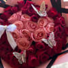Bouquet of pink and red roses with butterfly decorations