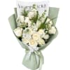 White rose bouquet wrapped in pale green paper with a ribbon