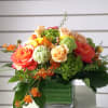 Mixed bouquet of roses and green hydrangeas in a glass vase