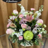 Basket arrangement of pink and white flowers with a green chrysanthemum