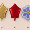 Three foil balloons: gold star, red star, and a purple flower shape.