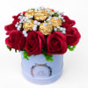 Red roses with gold-wrapped chocolates in a white hat box