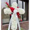 White floral cross with red roses and a white ribbon