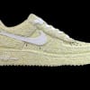 A pale yellow Nike sneaker covered in textured floral material