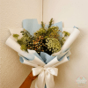 Handheld bouquet of white and green flowers wrapped in blue and white paper