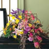 Colorful floral spray on a dark casket