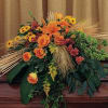 Large orange and yellow floral arrangement with roses and lilies
