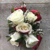 White rose bouquet with small white filler flowers and red ribbon