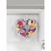 Heart-shaped floral arrangement with mixed colorful flowers