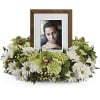 Framed photo surrounded by white and green flowers