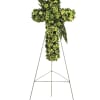 Green floral cross on a metal easel