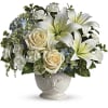 White lilies and cream roses in a decorative vase