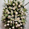 Large white floral standing spray with roses and lilies