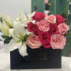 Pink and white roses with white lilies in a black box