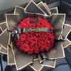 Bouquet of red roses wrapped in black paper with gold trim