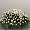 Large white rose and orchid arrangement on a stand