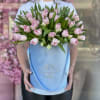 Pink tulips arranged in a light blue hatbox