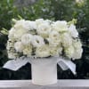 White rose and carnation bouquet in a white hatbox
