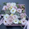 Pink and white bouquet in a pink box with macarons