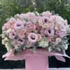 A soft, romantic statement in shades of pink, this charming arrangement is