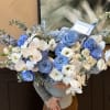 Large bouquet of blue and white roses with white orchids