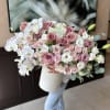 Large bouquet of pink roses and white orchids in a white box