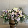 Large pastel flower arrangement in a woven basket