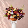 Mixed roses and hydrangeas arranged in a pumpkin vase