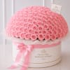 Large dome of pink roses in a round hatbox with a pink ribbon