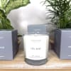 Soy candle in a glass jar with two matching boxes beside it