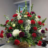 Large basket arrangement of red, white, and purple flowers
