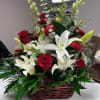 Basket arrangement of red roses and white lilies