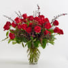 Red roses arranged in a clear glass vase