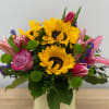 Bouquet with sunflowers, pink tulips, and roses in a vase