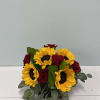 Sunflowers and red roses arranged in a low bouquet