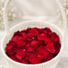 White basket filled with red rose petals