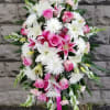 Standing floral spray with pink roses, white lilies, and white daisy-like blooms
