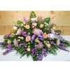 Large purple and peach floral spray with a lavender ribbon